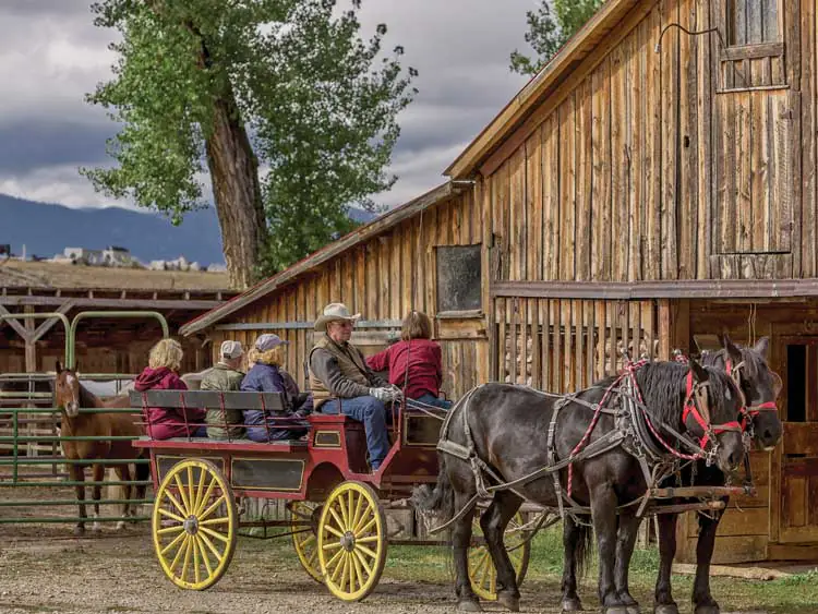 Guests on wagon rise at TA Guest Ranch in Buffalo Wyoming