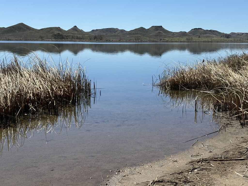 A peaceful view of Healy Reservoir in Wyoming, known as one of the best places to go fishing for trout, perch, and musky.