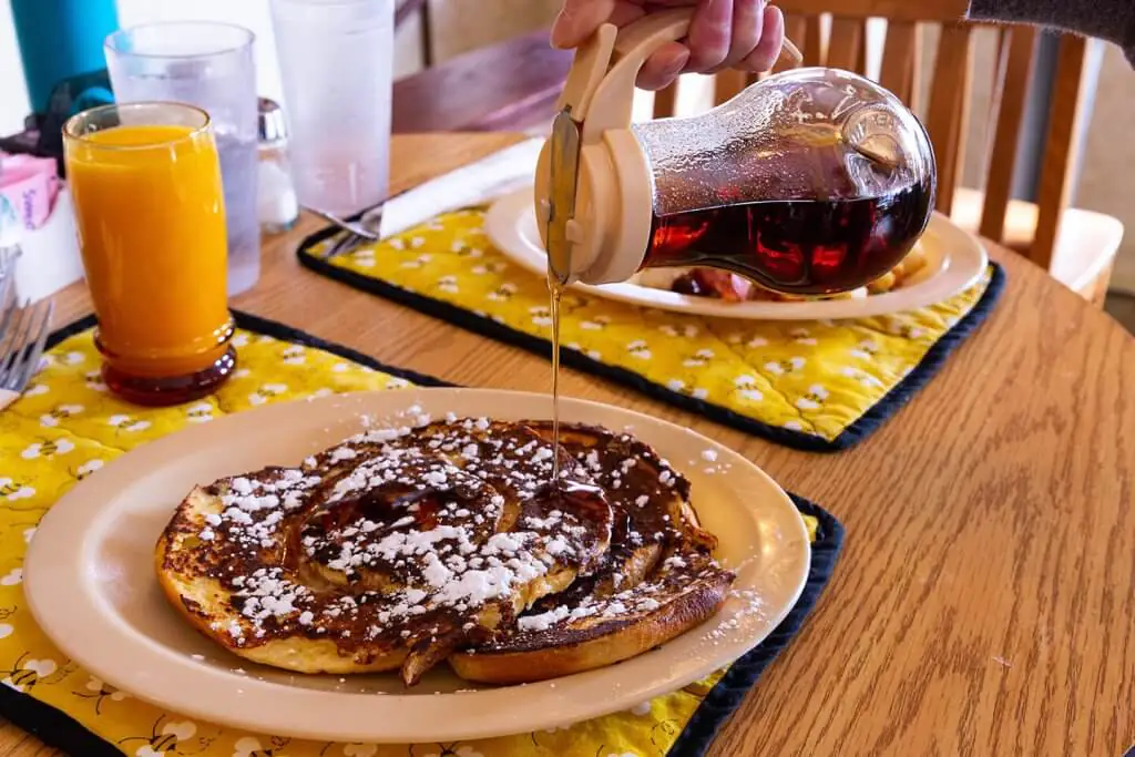 Maple syrup is poured onto a plate of French toast at the Busy Bee Cafe in Buffalo, Wyoming.