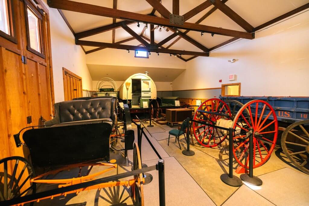 An interior view of Jim Gatchell Memorial Museum, displaying historical wagons and artifacts, a kid-friendly thing to do for an educational activity in Buffalo.