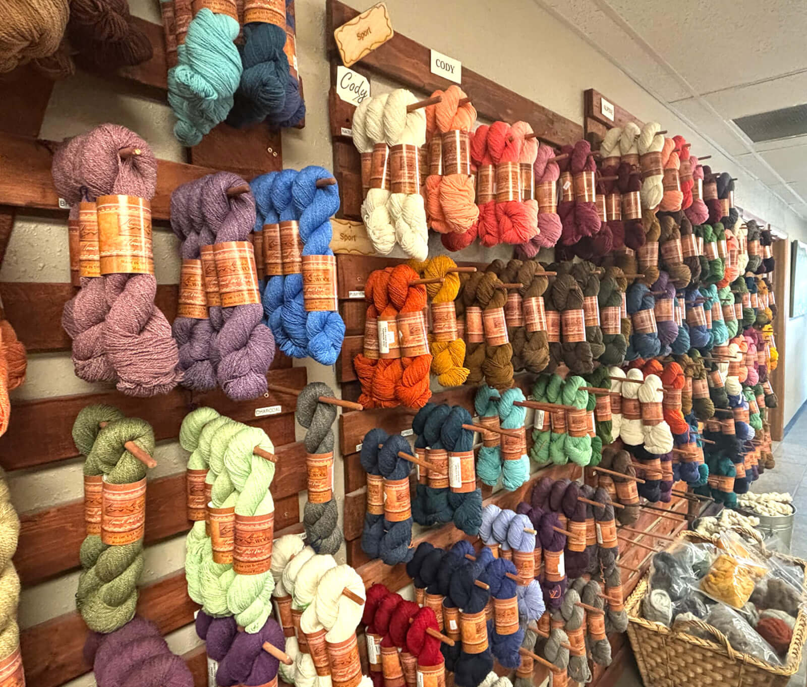 Colorful skeins of yarn displayed on a wall at Mountain Meadow Wool, a unique thing to do for families in Buffalo, WY.