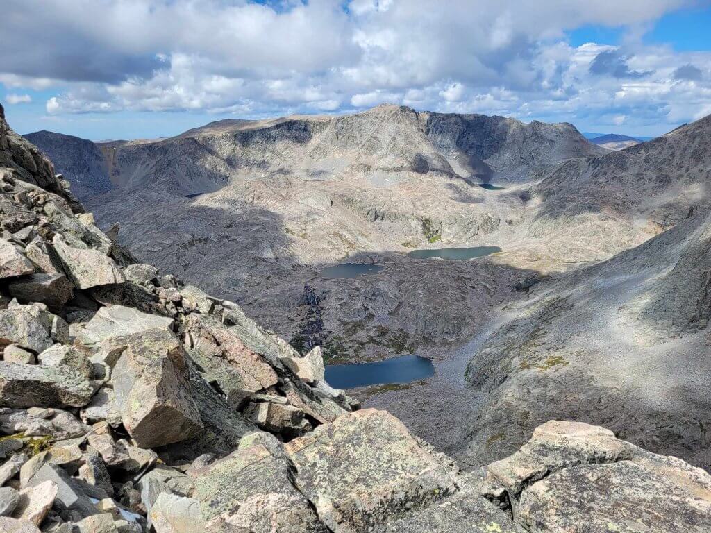 Hiking in Cloud Peak Wilderness Area, featuring rocky terrain and alpine lakes, known for being challenging hike in Wyoming.