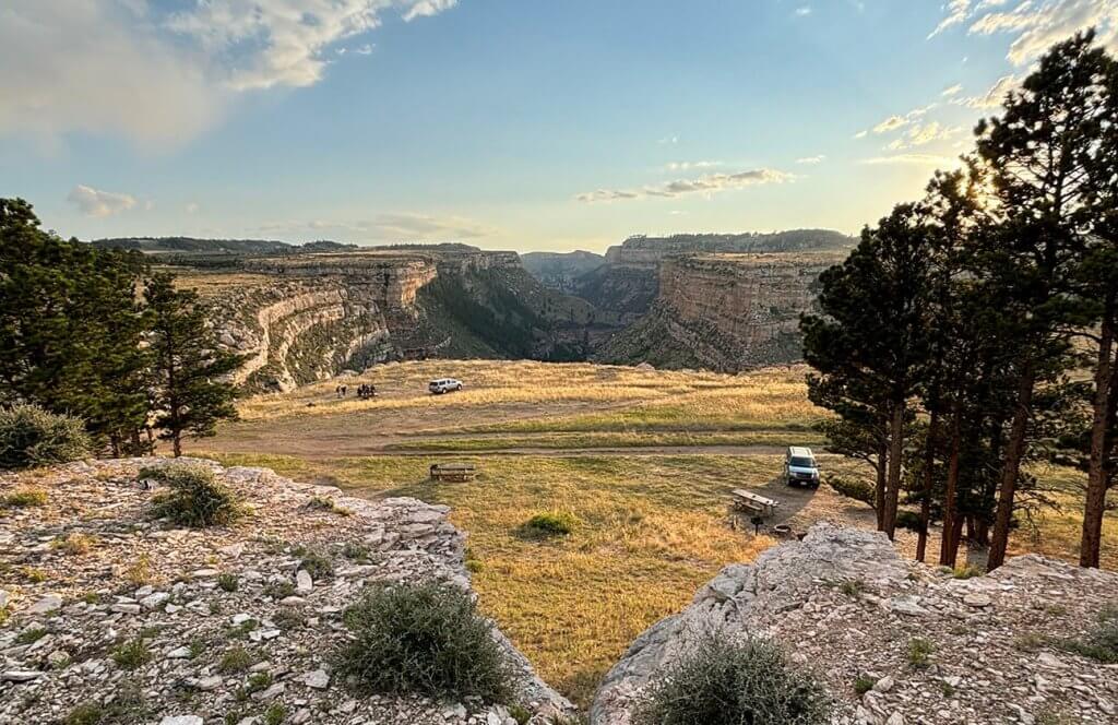 View from Outlaw Canyon Campground, the starting point of the Outlaw Cave Trail, one of the best places to hike in Buffalo, with views of the canyon and Middle Fork of the Powder River below.