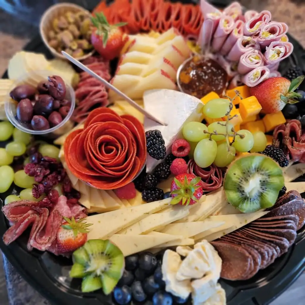 Elegant catering grazing platter featuring assorted cheeses, meats, fresh fruits, and olives, ideal for events and gatherings in Buffalo, Wyoming.