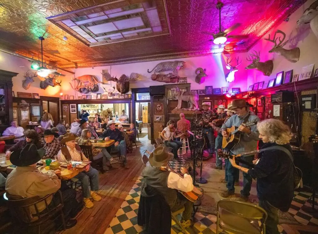 Live music and dining at the historic Occidental Saloon in Buffalo, Wyoming, featuring a lively atmosphere, delicious food, and unique decor.