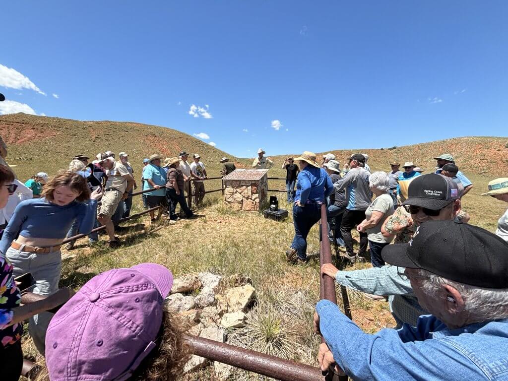 Hole in the Wall Guided Hole-in-the-Wall Tour with large group of visitors learning about local history at outdoor interpretive station
