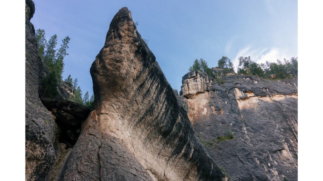 Origins of Crazy Woman Canyon View of towering canyon walls in Crazy Woman Canyon, evoking the dramatic setting of the frontier legends and film adaptations.