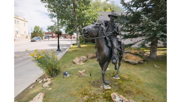 20 Free and Budget-Friendly Things to Do in Buffalo, Wyoming A bronze statue near Main Street and trail signage — ideal for geocaching hotspots around Buffalo’s historic core.