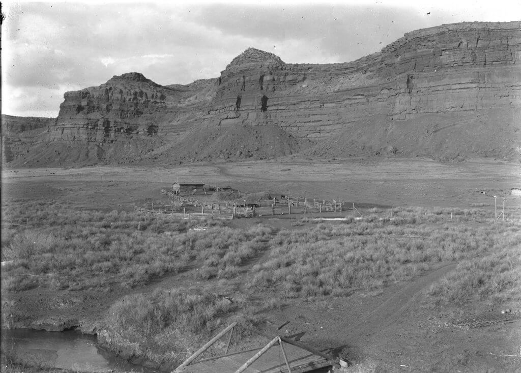 Hole in the Wall Historic photo of Hole-in-the-Wall in Johnson County, Wyoming, showing the remote outlaw hideout nestled beneath red rock cliffs and surrounded by rugged rangeland