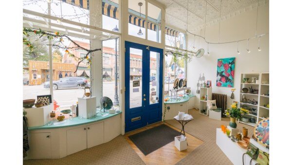20 Free and Budget-Friendly Things to Do in Buffalo, Wyoming View through the window of Margo’s Pottery shop, with artisan ceramics and downtown Buffalo visible outside.