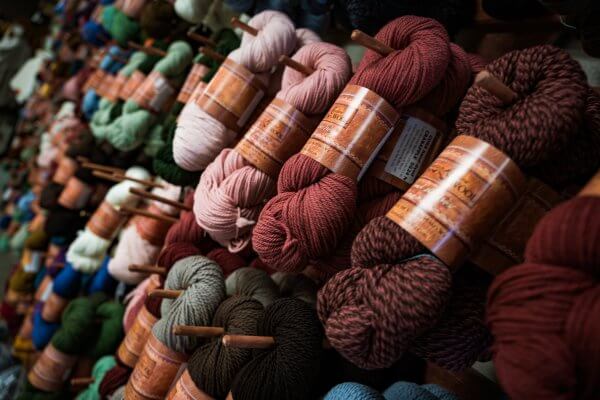 20 Free and Budget-Friendly Things to Do in Buffalo, Wyoming Shelves of vibrant hand-dyed wool skeins inside the Mountain Meadow Wool Mill in Buffalo.