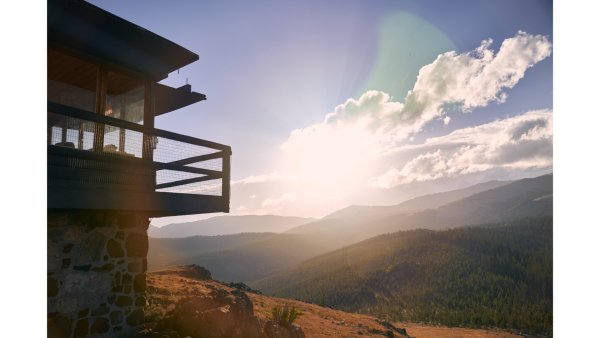 20 Free and Budget-Friendly Things to Do in Buffalo, Wyoming View from a mountain lookout over a sunlit forest valley and distant peaks along the Cloud Peak Scenic Byway in the Bighorn Mountains near Buffalo, Wyoming, with golden light filtering through the clouds.