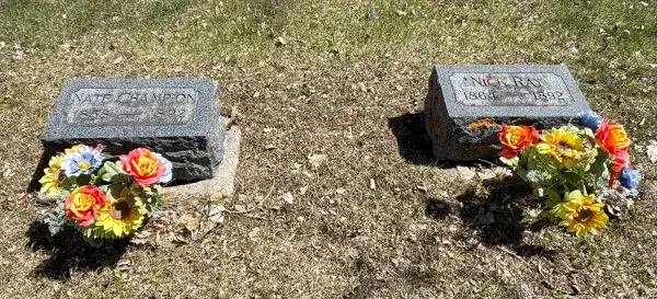20 Free and Budget-Friendly Things to Do in Buffalo, Wyoming Graves of Nate Champion and Nick Ray adorned with flowers at historic Willow Grove Cemetery.
