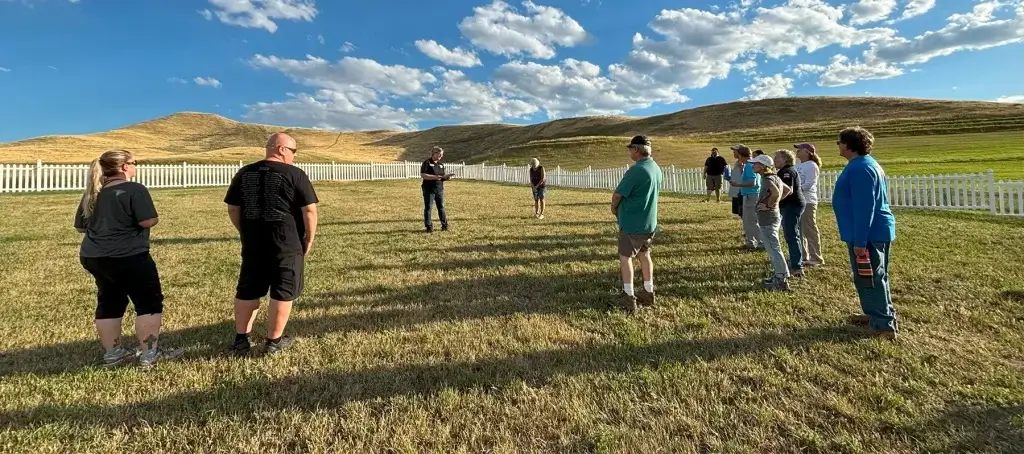 A group of people at a Fort Phil Kearny Cemetery Tour, a haunted place in Buffalo, WY.