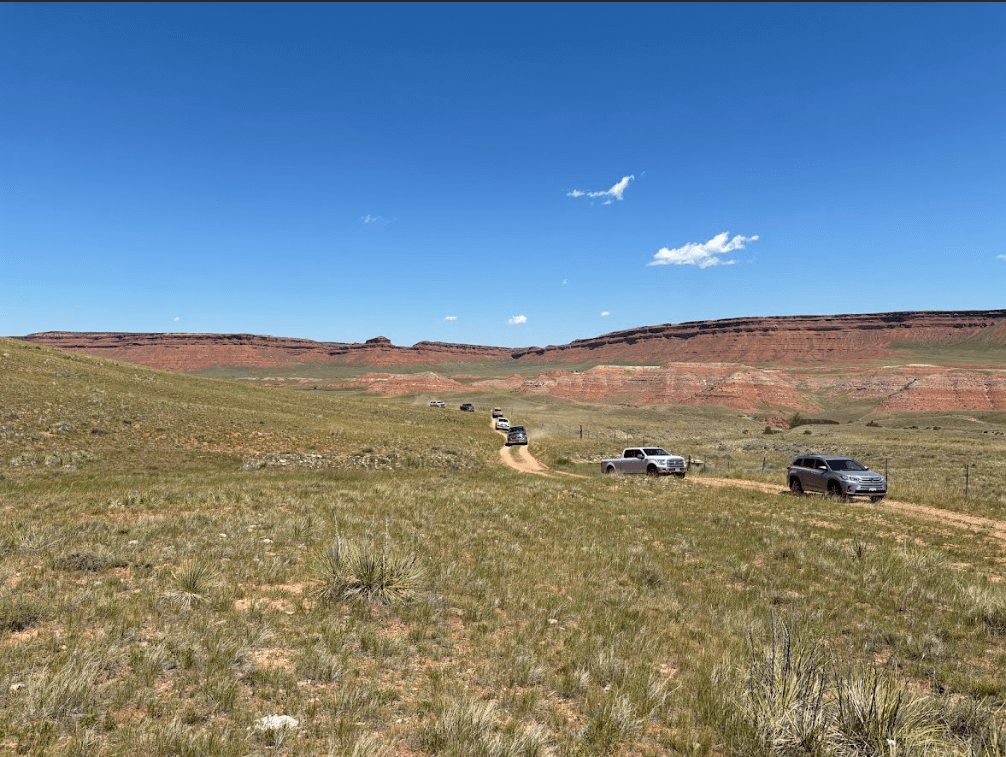 cars and trucks driving back from the Hole in the Wall in Kaycee, Wyoming