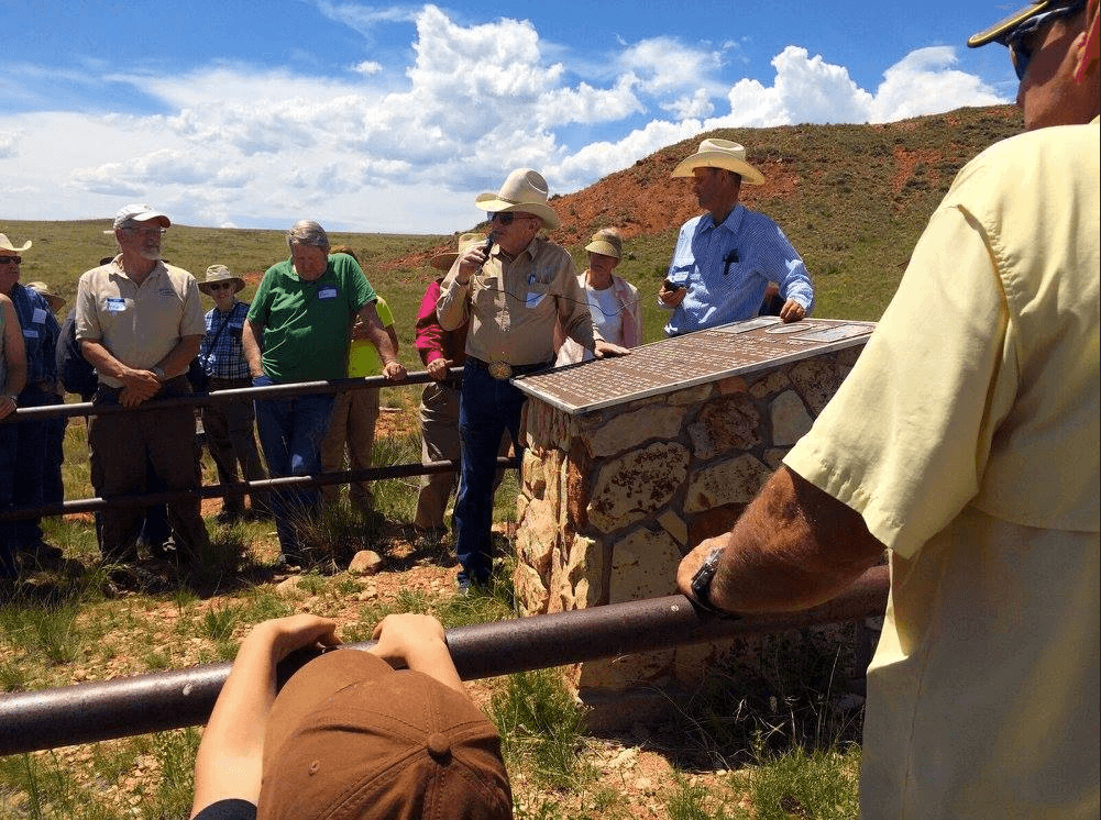 Hole in the Wall Tours Visitors gathered around the Hole in the Wall Memorial in the Red