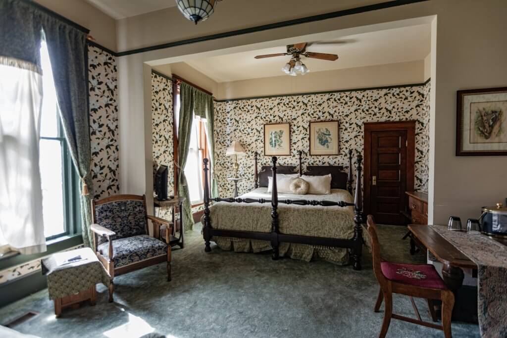 A king bed guest suite at the Occidental Hotel in Buffalo, Wyoming