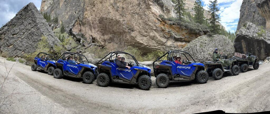 A line up of blue ATVs on an ATV tour in Buffalo, WY