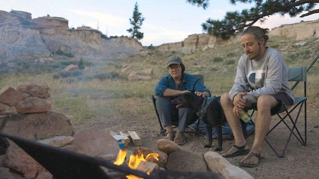 A couple and their pet dog campign at Outlaw Cave Camprground in Johnson County, Wyoming