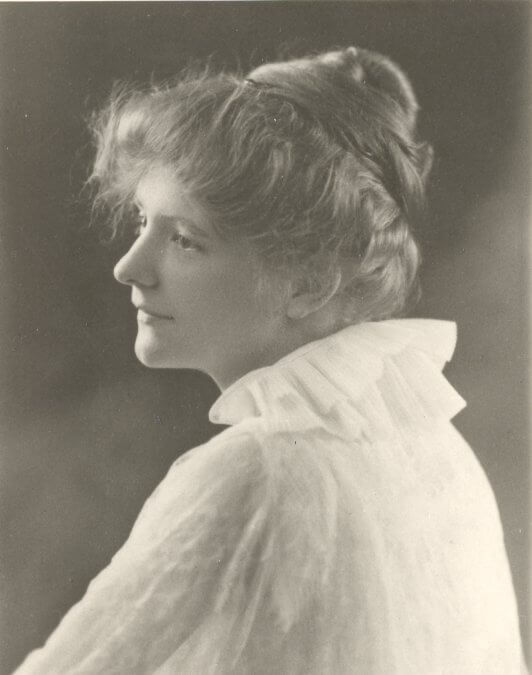 Verna Keays, a Buffalo, Wyoming resident and the designer of the Wyoming state flag, pictured in a vintage sepia-toned profile portrait wearing a high-collared white ruffled blouse.
